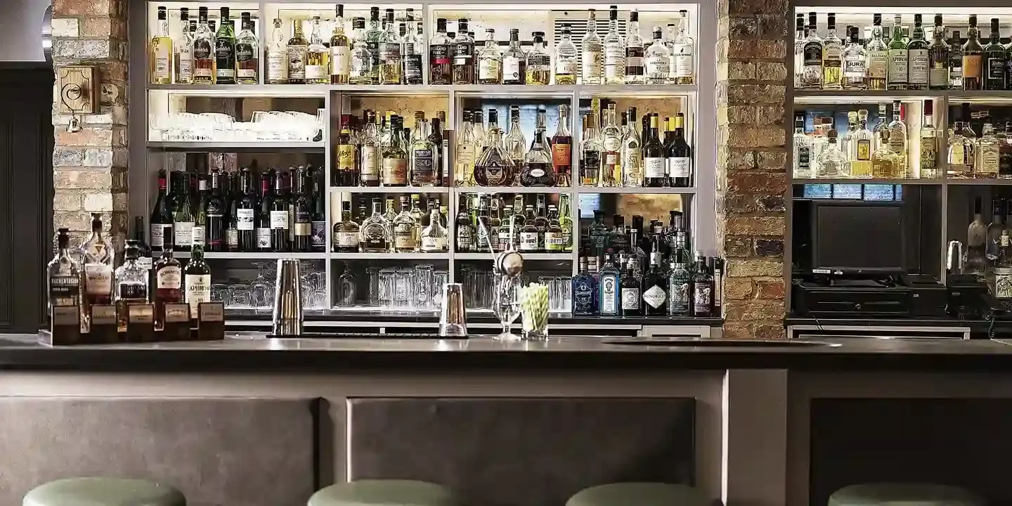 A well-stocked bar with an assortment of alcoholic beverages.