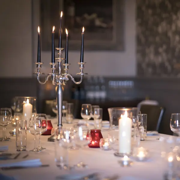 A beautifully arranged table adorned with elegant candles and wine glasses.