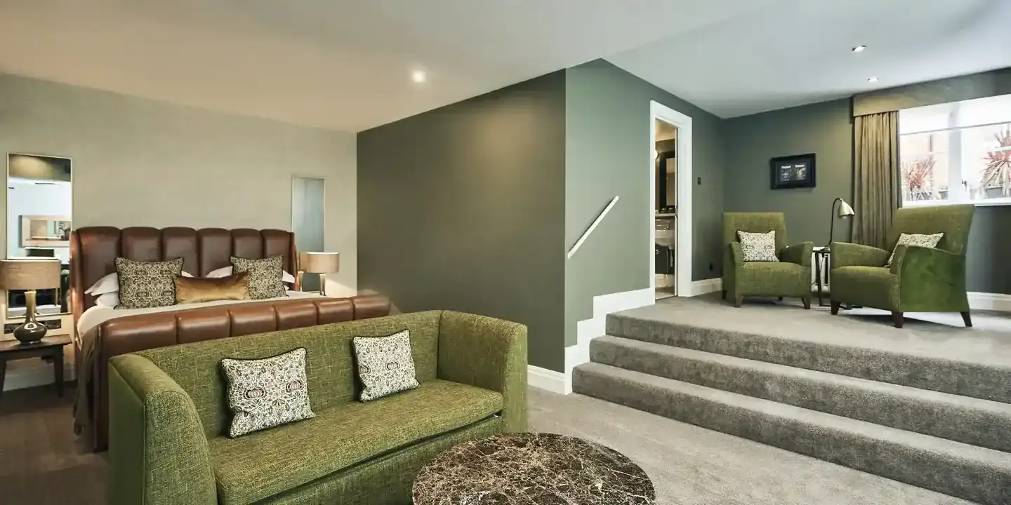 A well-furnished living room featuring a stylish green couch.