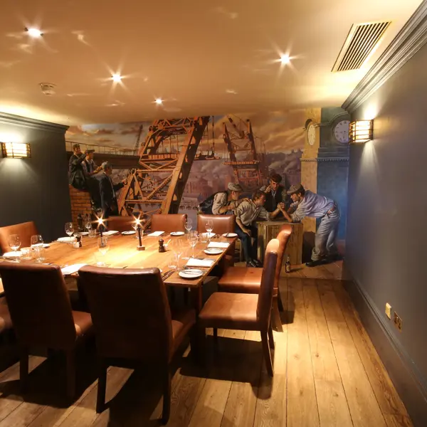 A dining room featuring a wooden table and brown chairs.