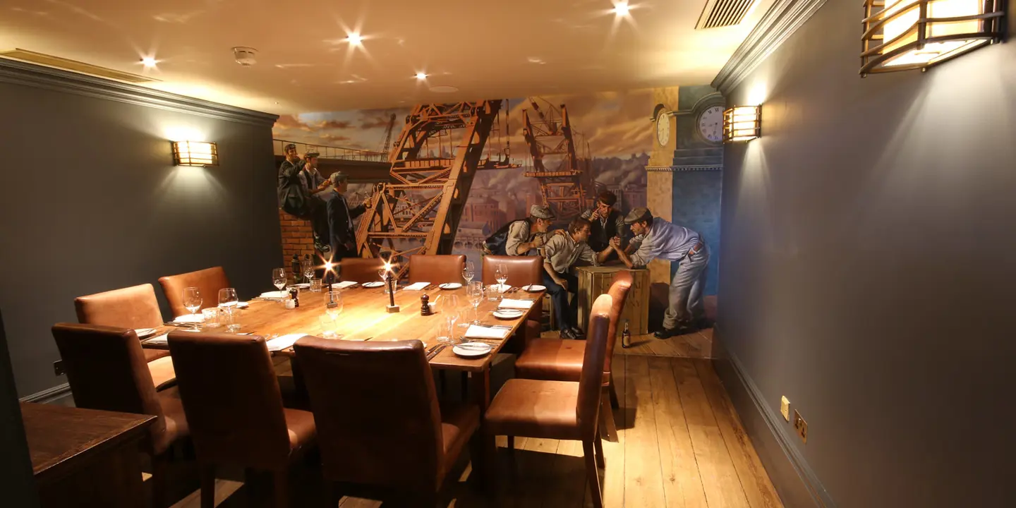 A dining room featuring a wooden table and brown chairs.