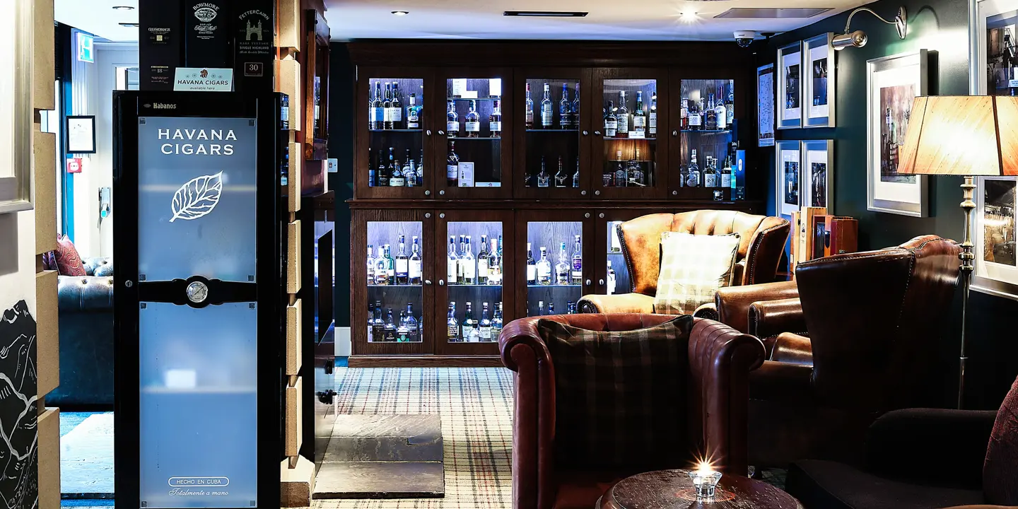 A hotel lobby featuring comfortable couches, chairs, and a convenient vending machine.