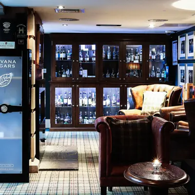 A hotel lobby featuring comfortable couches, chairs, and a convenient vending machine.