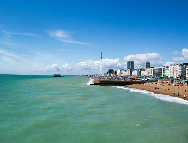Scenic beach view featuring individuals enjoying the seaside.