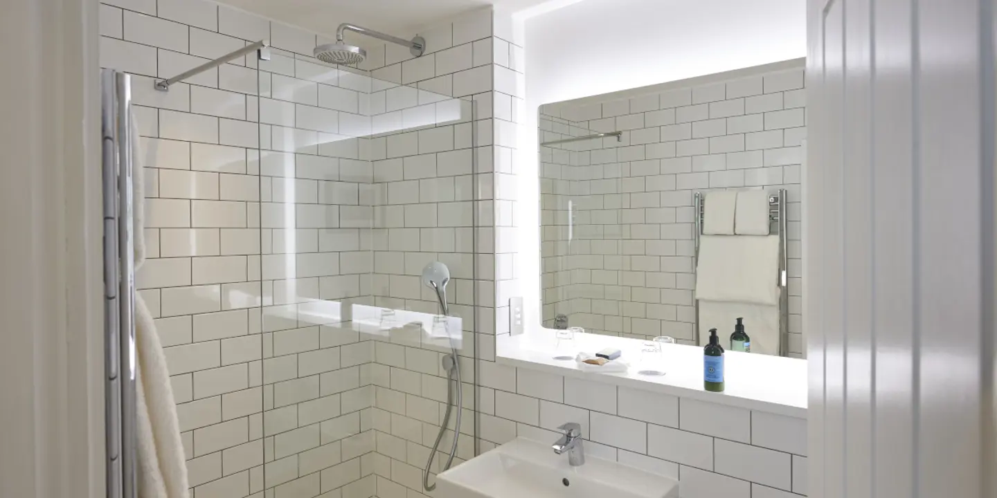 Bathroom featuring a sink and shower.