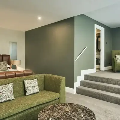 HDV Suite 6 with green sofa and armchairs