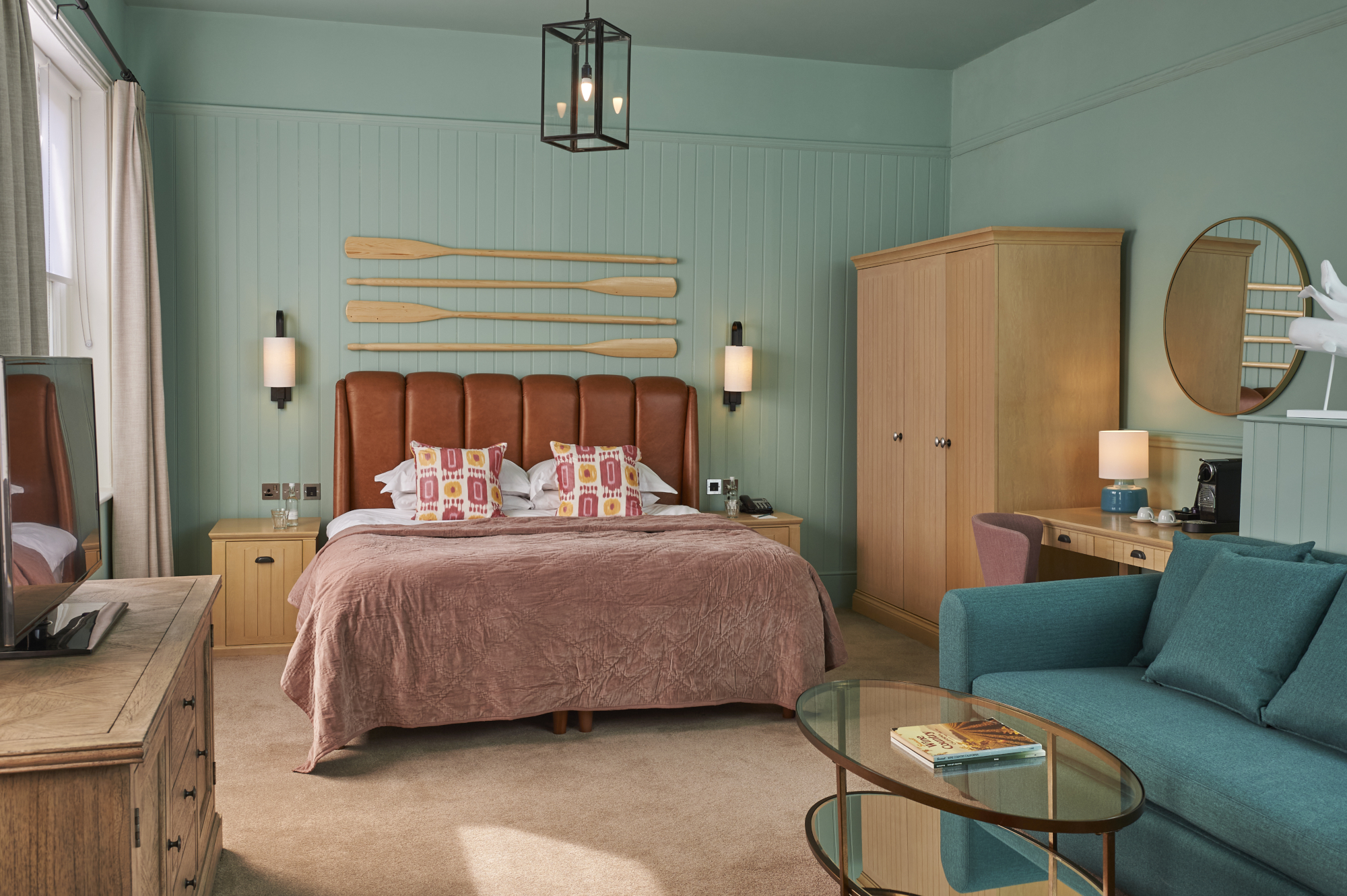 Spacious bedroom featuring a king-sized bed and an elegant chair.