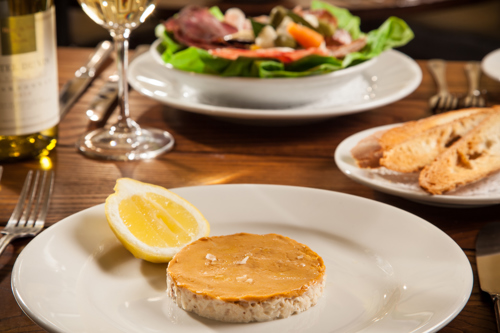 Close-up of fine dining meals served with wine.