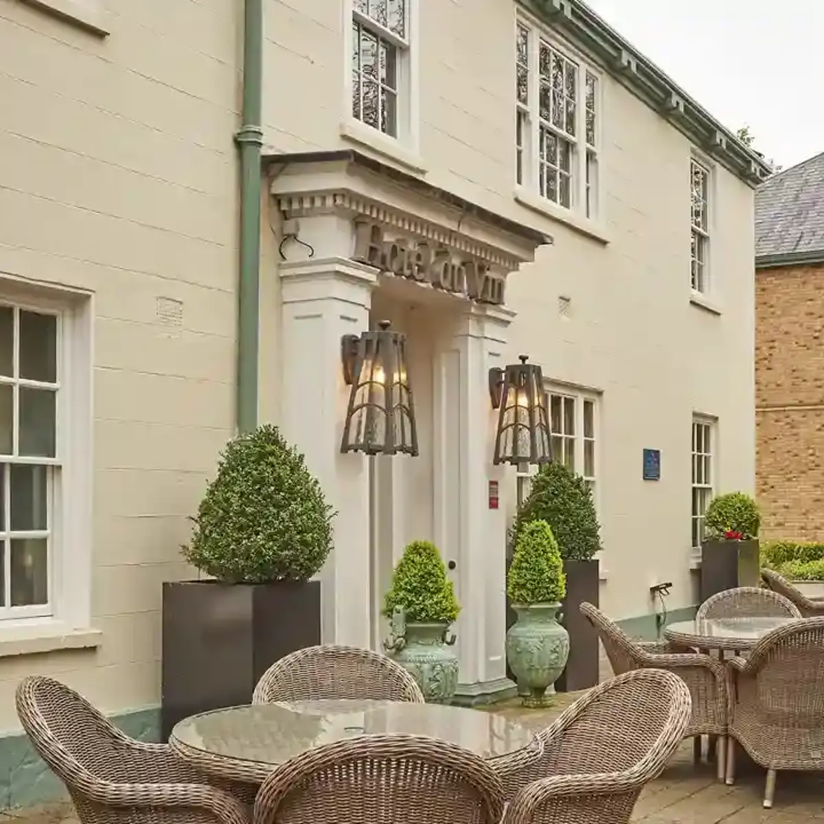A patio area featuring wicker chairs and tables.