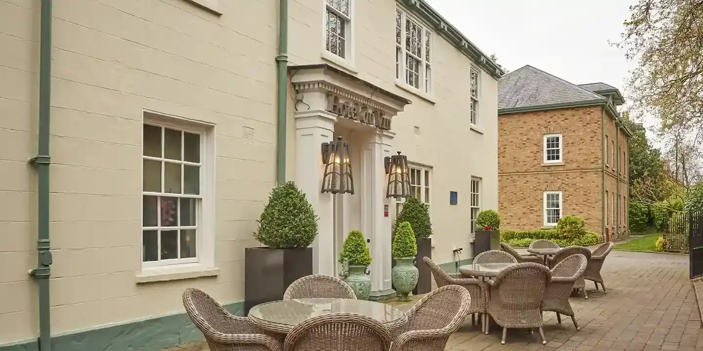 A patio area featuring wicker chairs and tables.