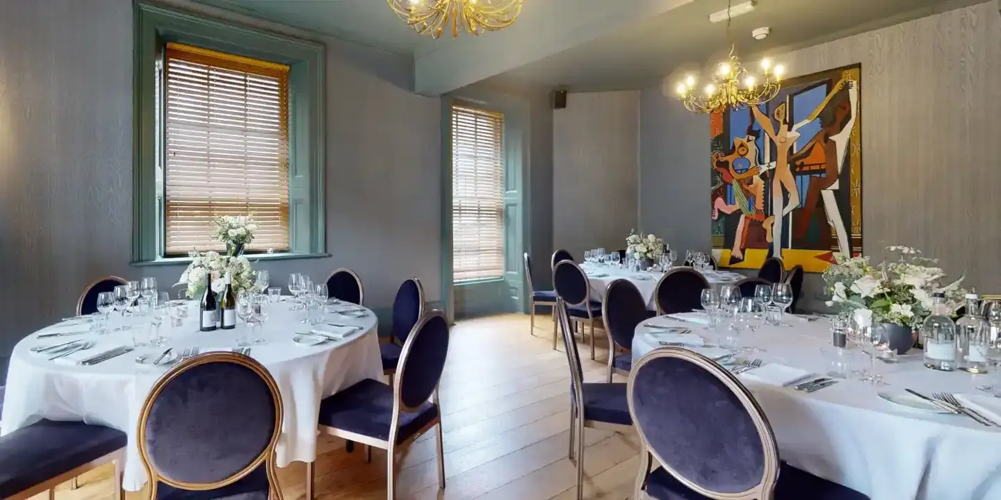 Dining room with round back chairs and gold chandelier 