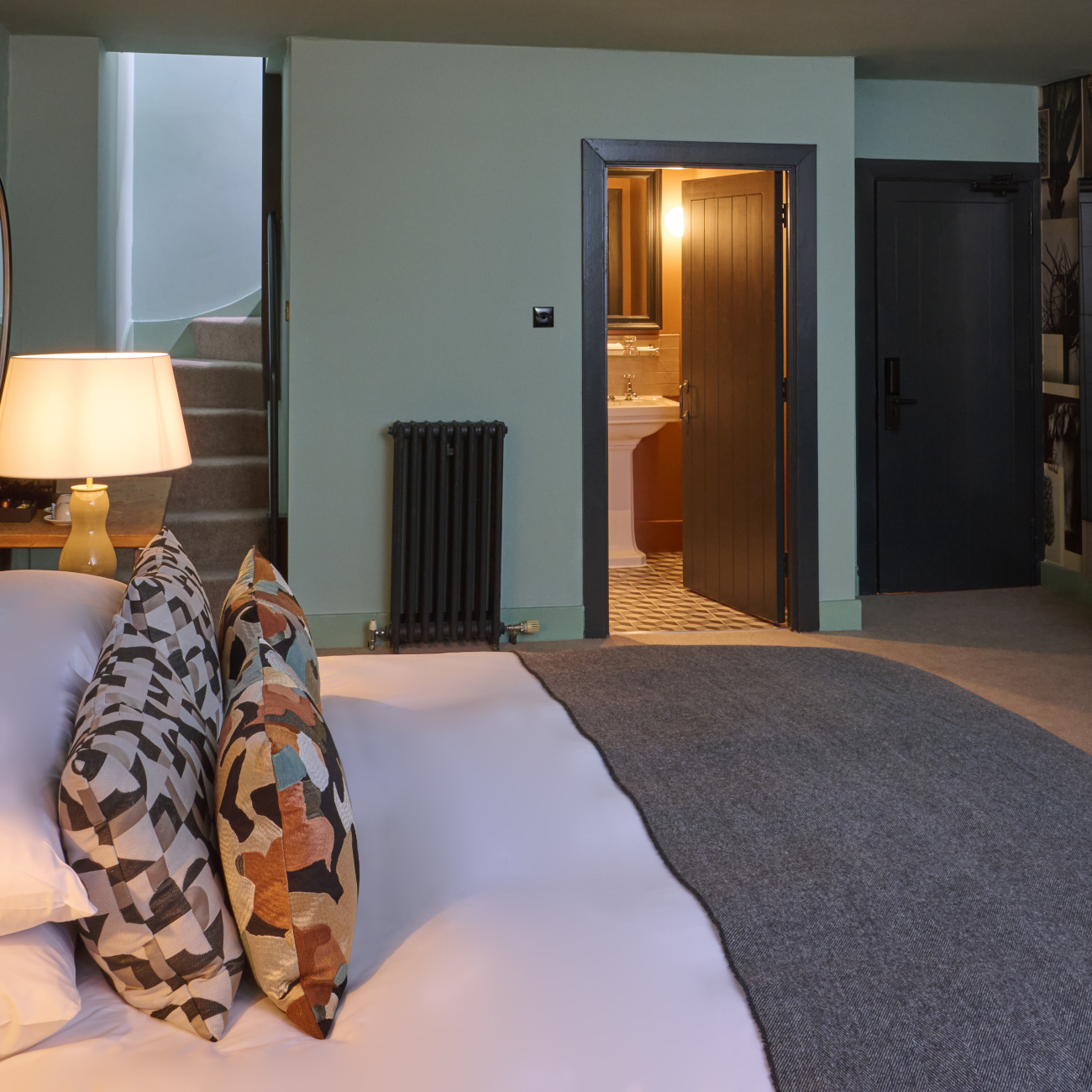 Bedroom featuring a comfortable bed, desk, and window.