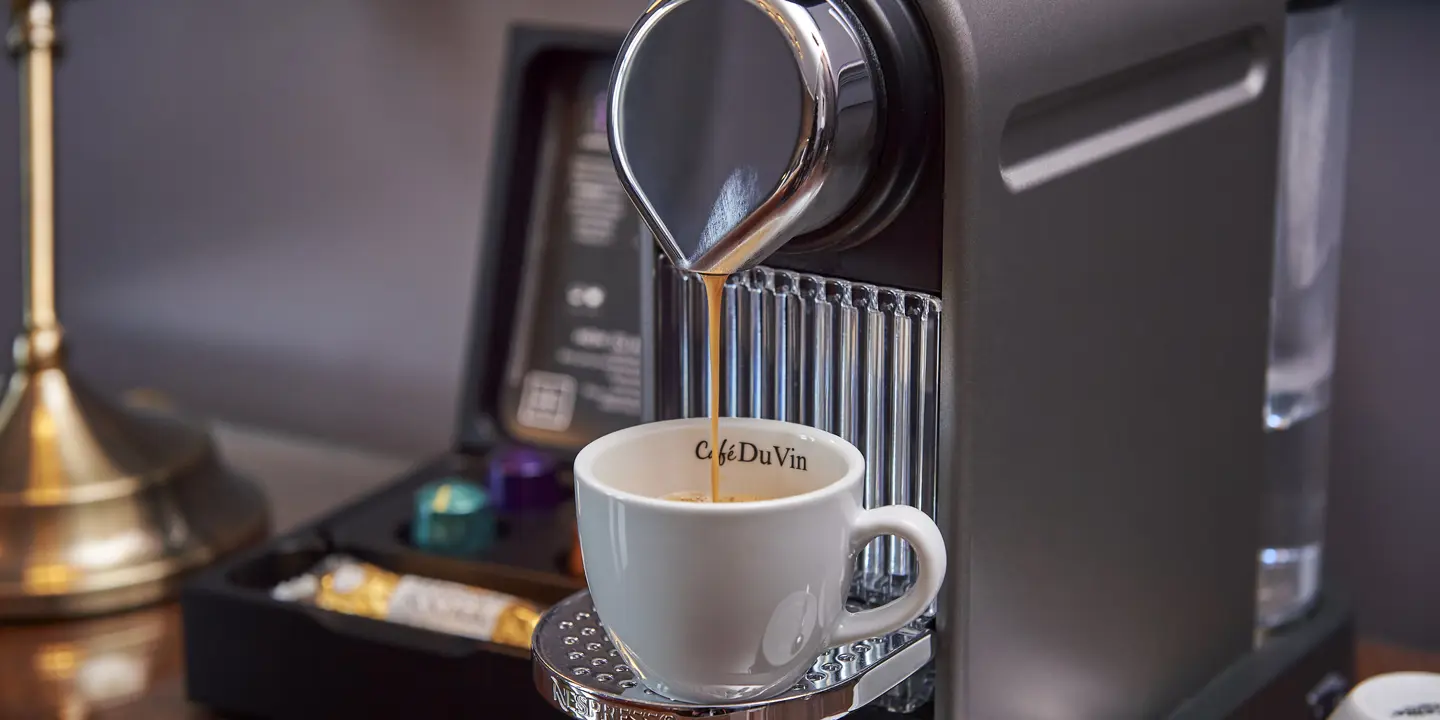 Pouring coffee from a coffee machine.