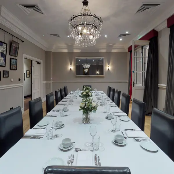 A dining room featuring a spacious table and chairs.