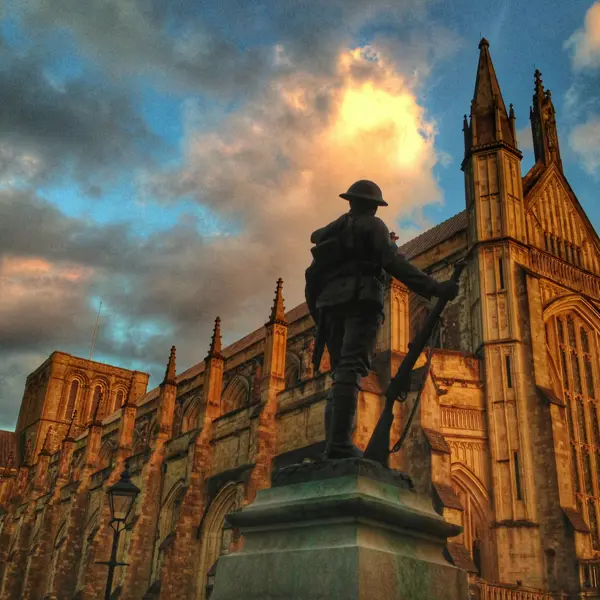 Statue of a soldier in front of a church.
