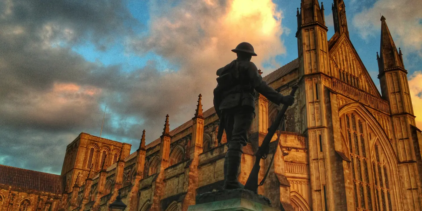 Statue of a soldier in front of a church.
