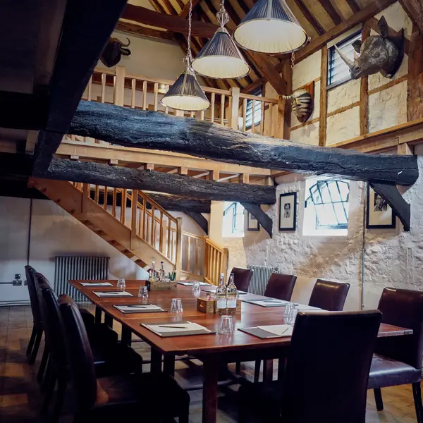 A dining room featuring a wooden table and chairs.