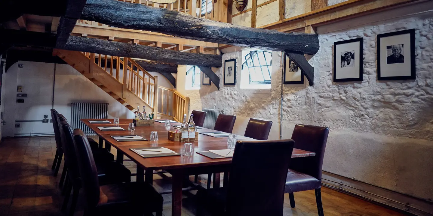 A dining room featuring a wooden table and chairs.