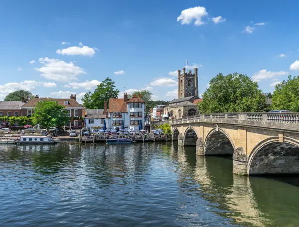 Henley Bridge spanning a body of water with buildings in the background.