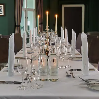 Table set for a formal dinner with candles.