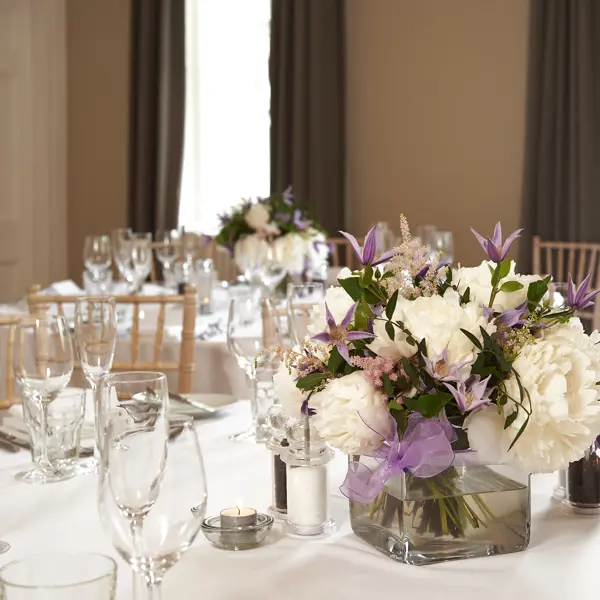 Table with a vase containing flowers.