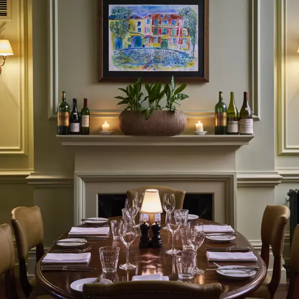 An assorted wooden dining table with empty wine glasses set up