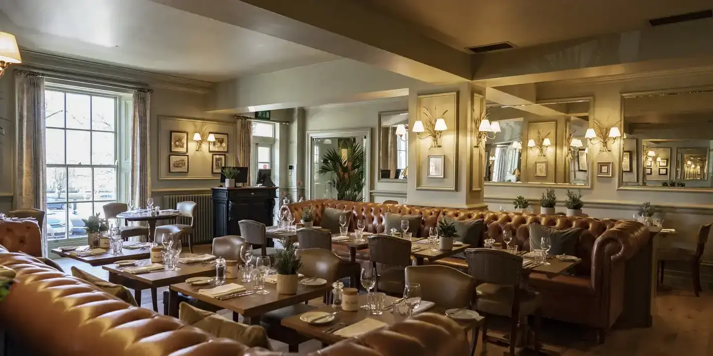 A spacious dining room filled with numerous tables and chairs.