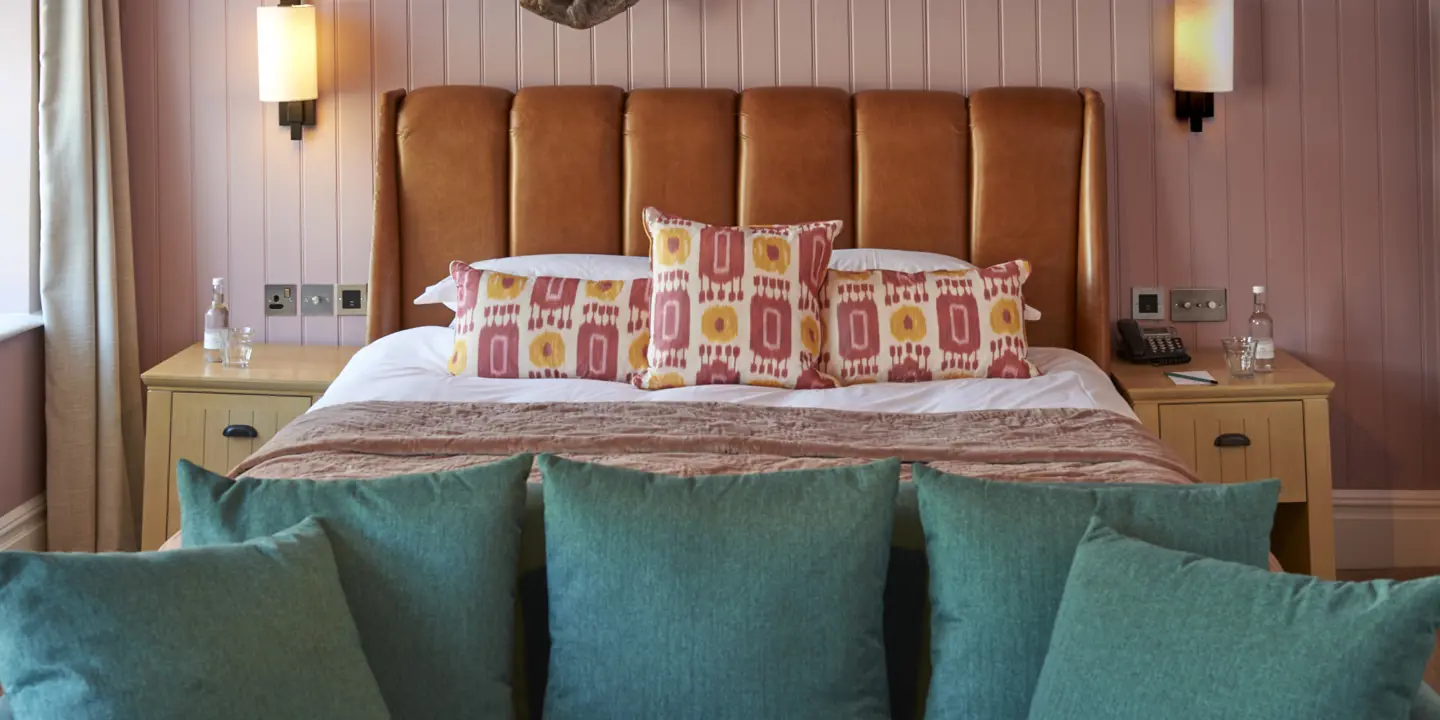 Bedroom featuring a comfortable bed and a stylish couch.