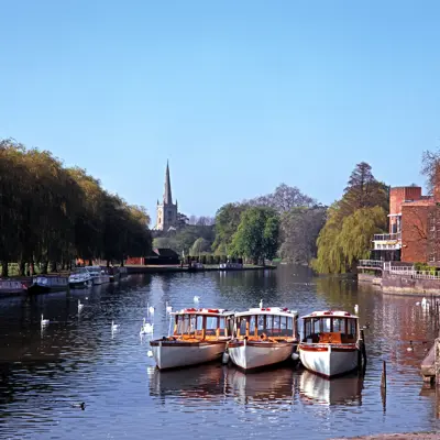 Several boats peacefully floating on a serene river.