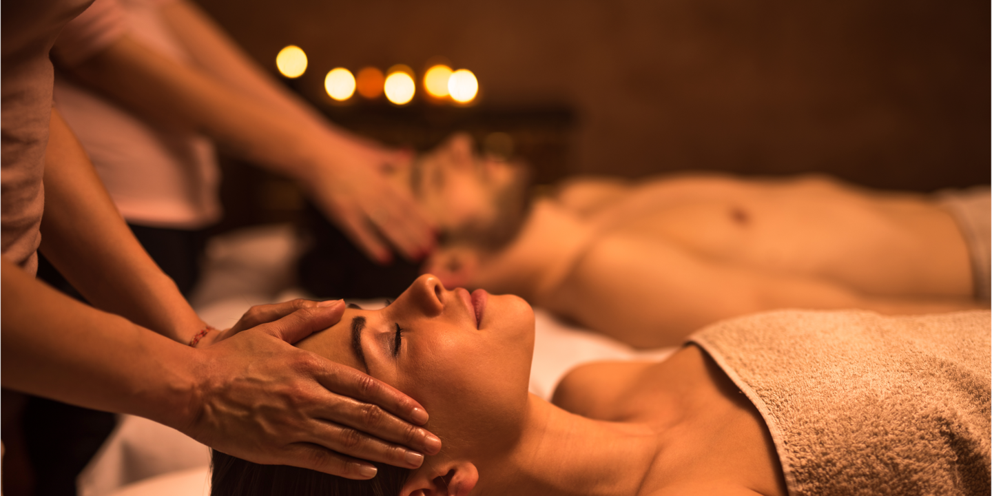 A woman receiving a facial massage at a spa.