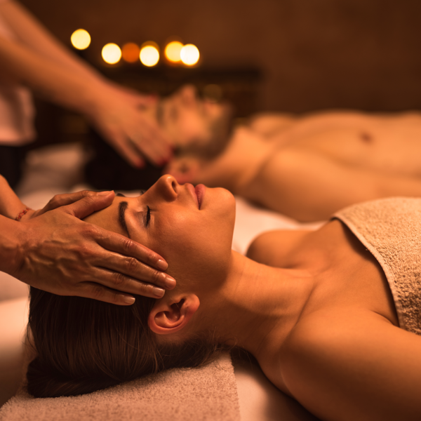 A woman receiving a facial massage at a spa.