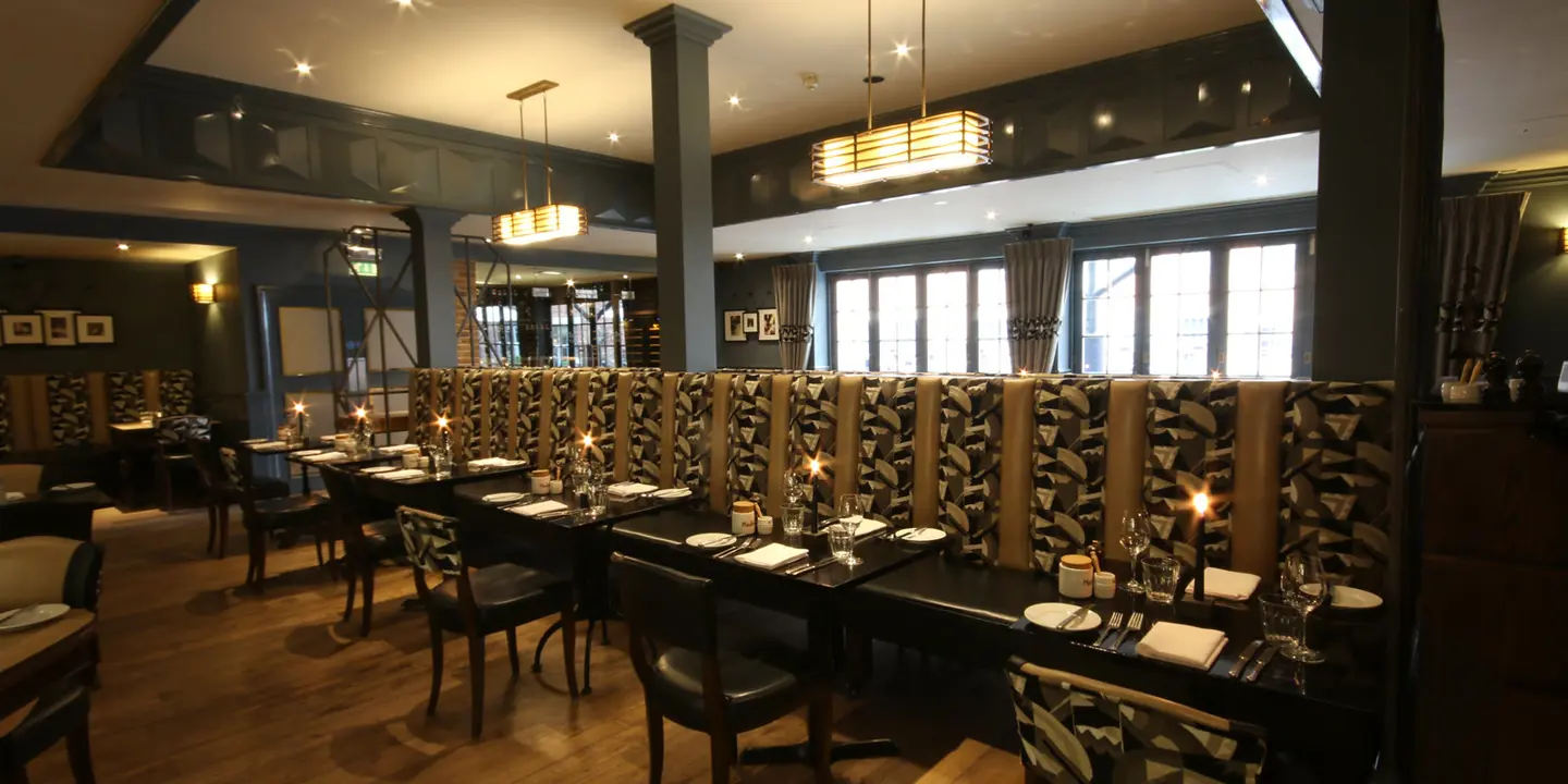 A dining room featuring a spacious table and chairs.