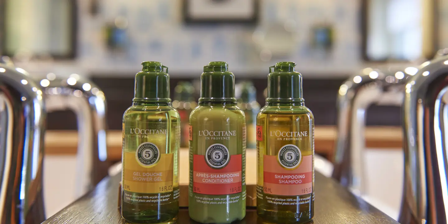 Three bottles of olive oil placed on a table.