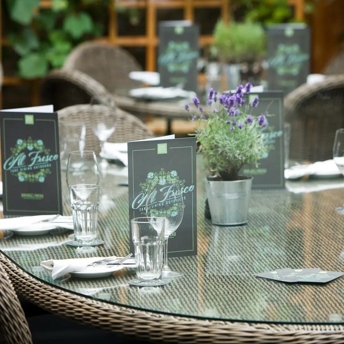 A table adorned with neatly arranged place settings and elegant place cards.