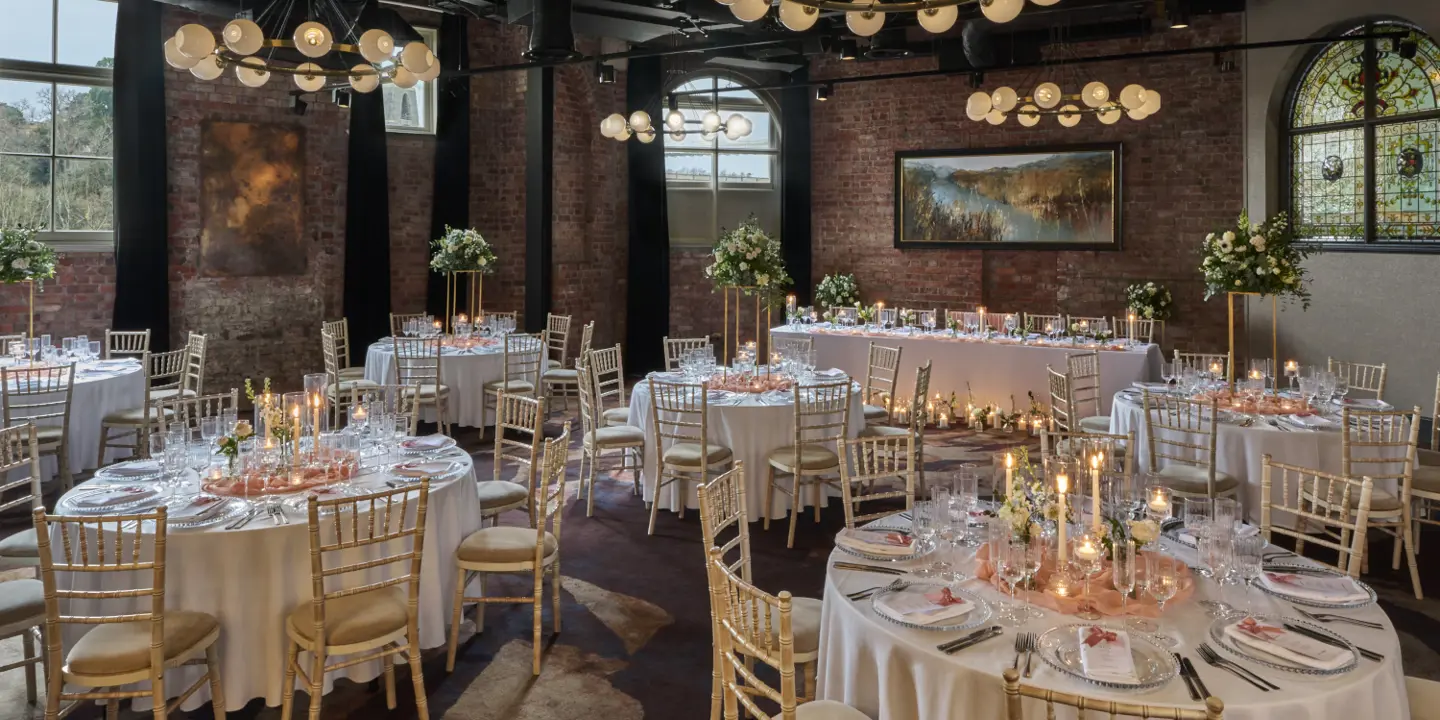 A spacious room with neatly arranged tables and chairs.