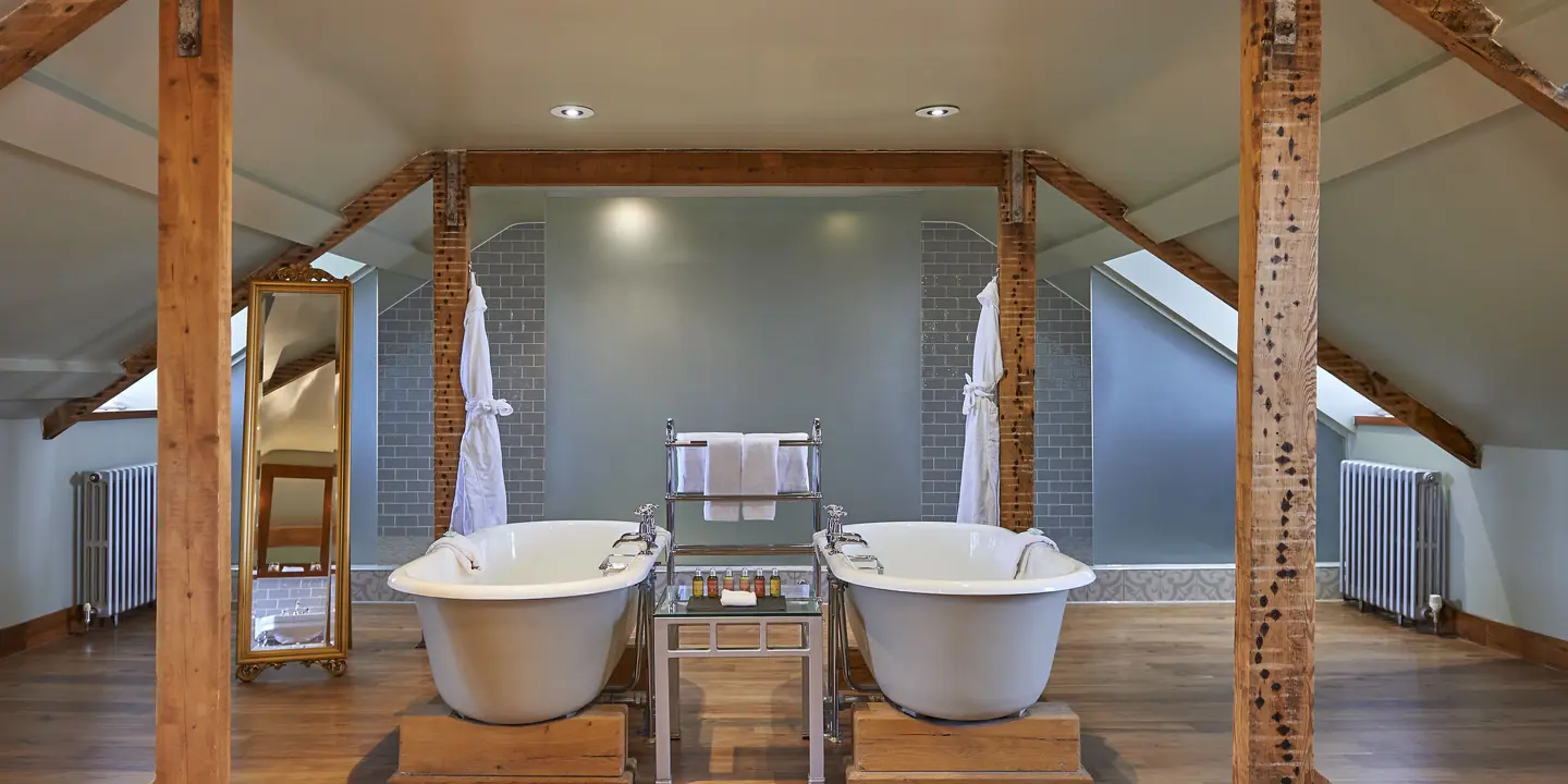 Bathroom featuring a bathtub and two sinks