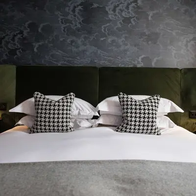 Bed with two pillows resting on top.
