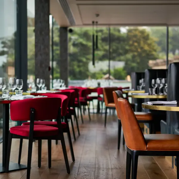 A restaurant featuring numerous tables and chairs.