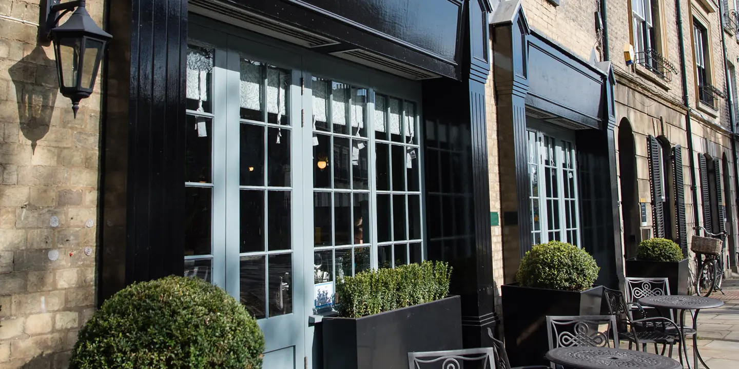 Outdoor seating area with tables and chairs.