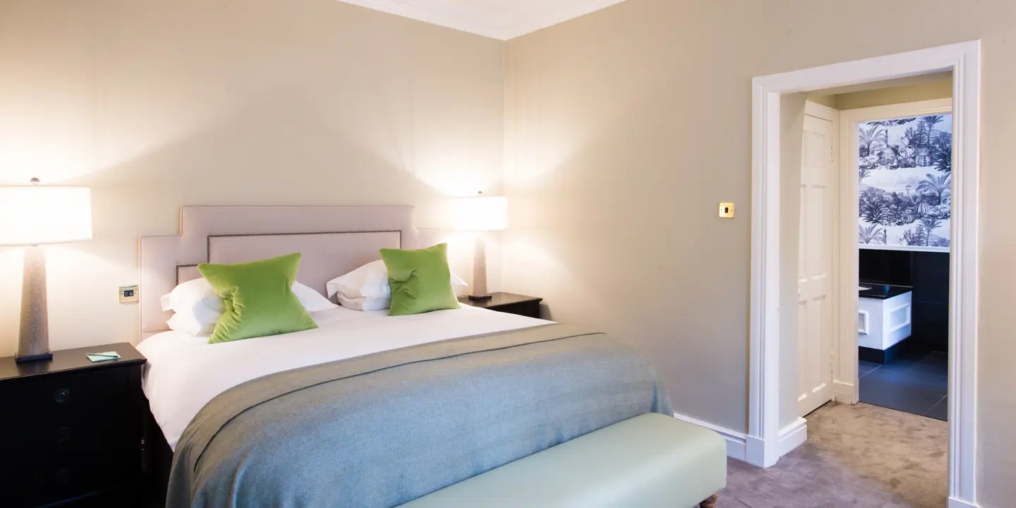 Bedroom featuring a comfortable bed and a stylish bench.