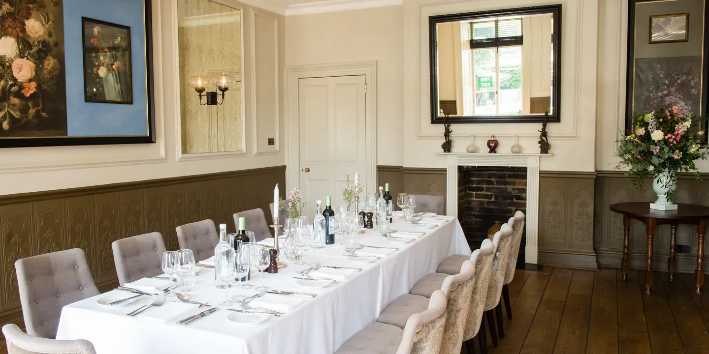 A dining room featuring a spacious table and chairs.