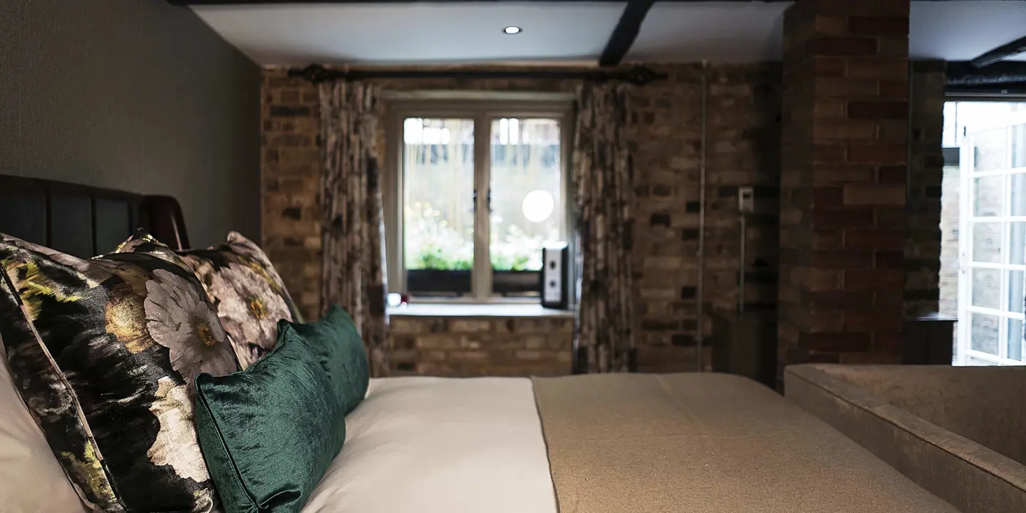 Bedroom featuring a comfortable bed and a window.