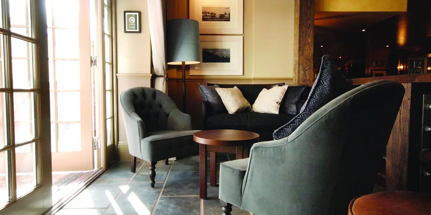 A well-furnished living room adjacent to a window.