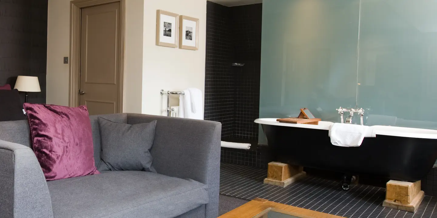 An elegantly furnished living room with a bathtub.