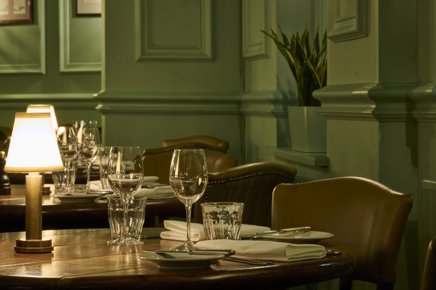 Prepared wooden dining table with seating and mood lighting