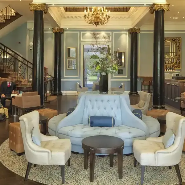 A well-furnished living room featuring a cozy fireplace and chandelier. 