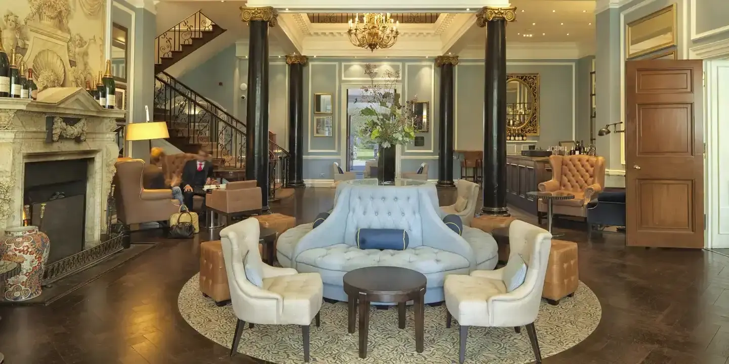 A well-furnished living room featuring a cozy fireplace and chandelier. 