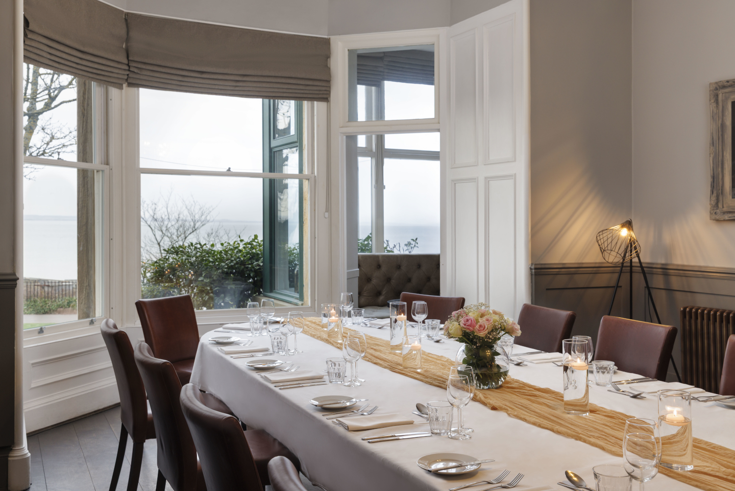 A beautifully arranged table adorned with elegant candles and wine glasses.