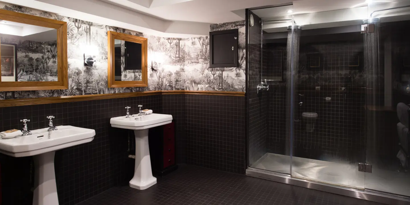 Bathroom featuring two sinks and a shower.