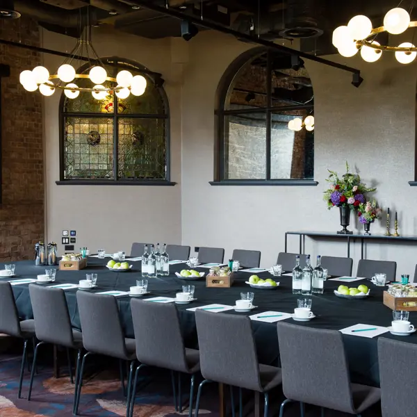 A beautifully arranged long table with elegantly set place settings.